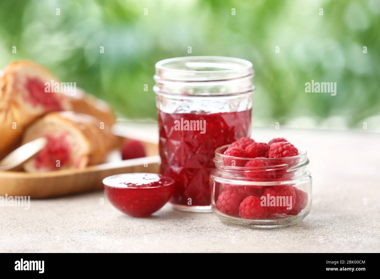 Tasty raspberry jam with berries on table Stock Photo