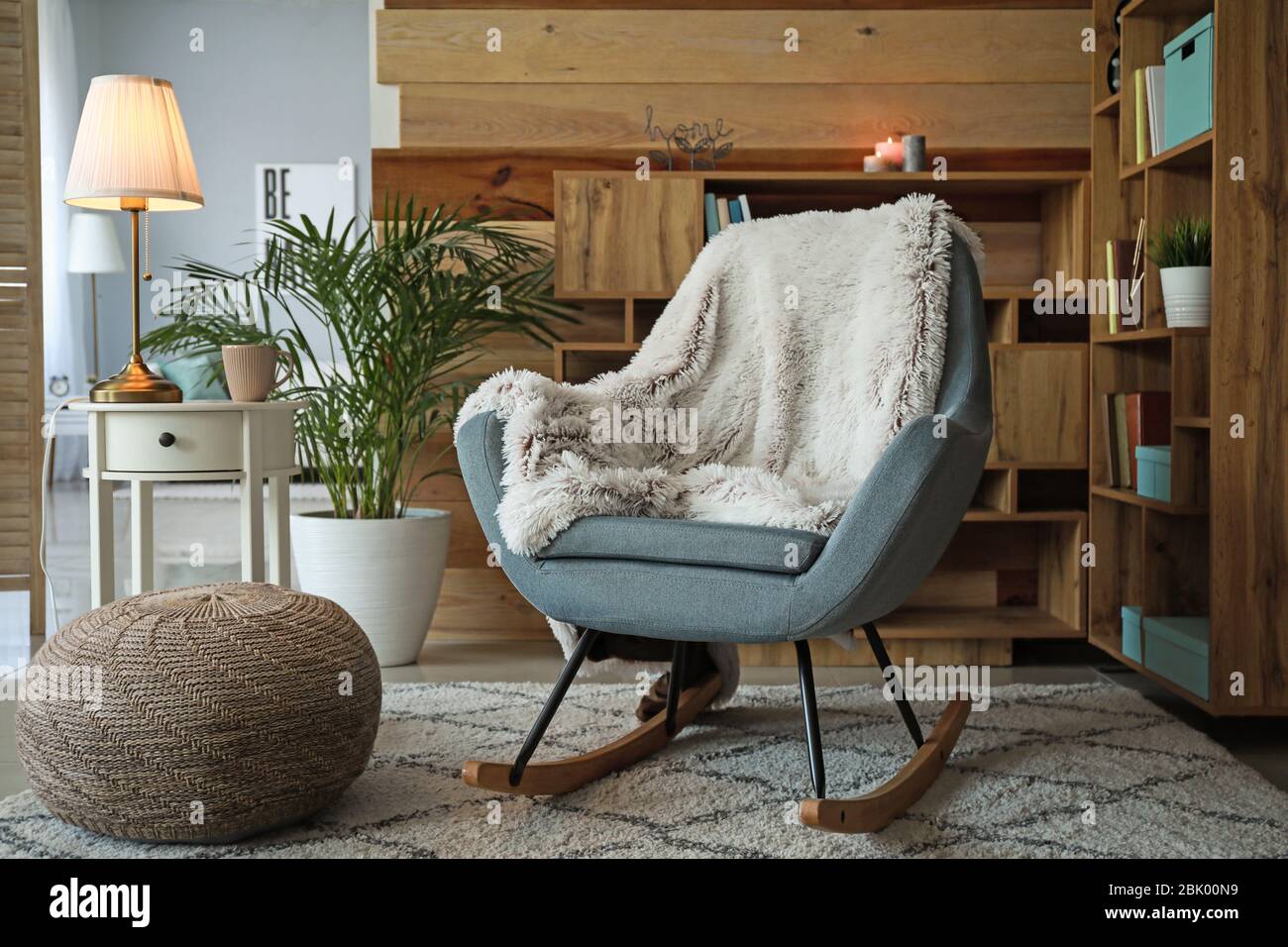 Cozy rocking chair in interior of living room Stock Photo - Alamy