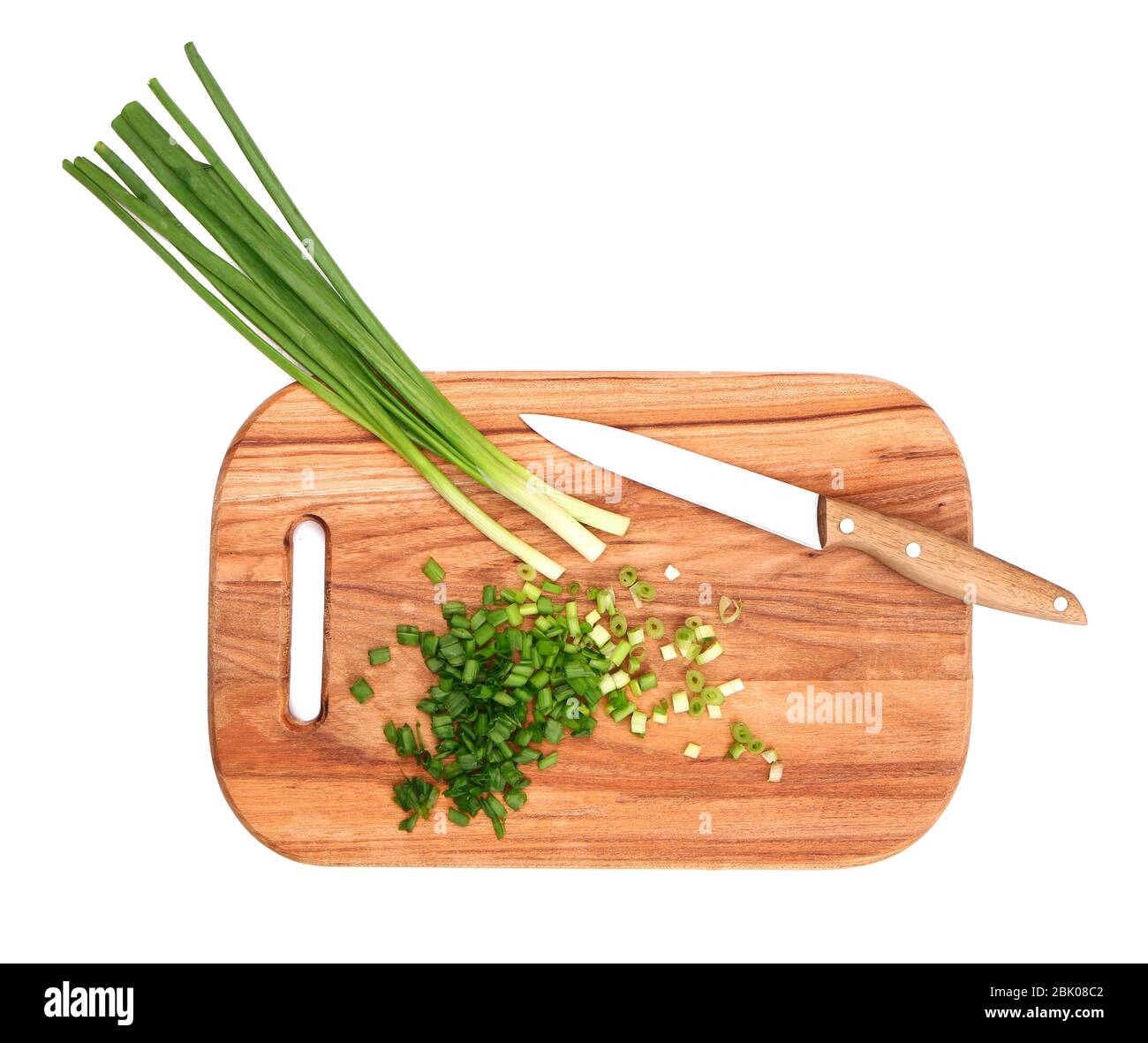 Cutting board with fresh green onion and knife on white background ...