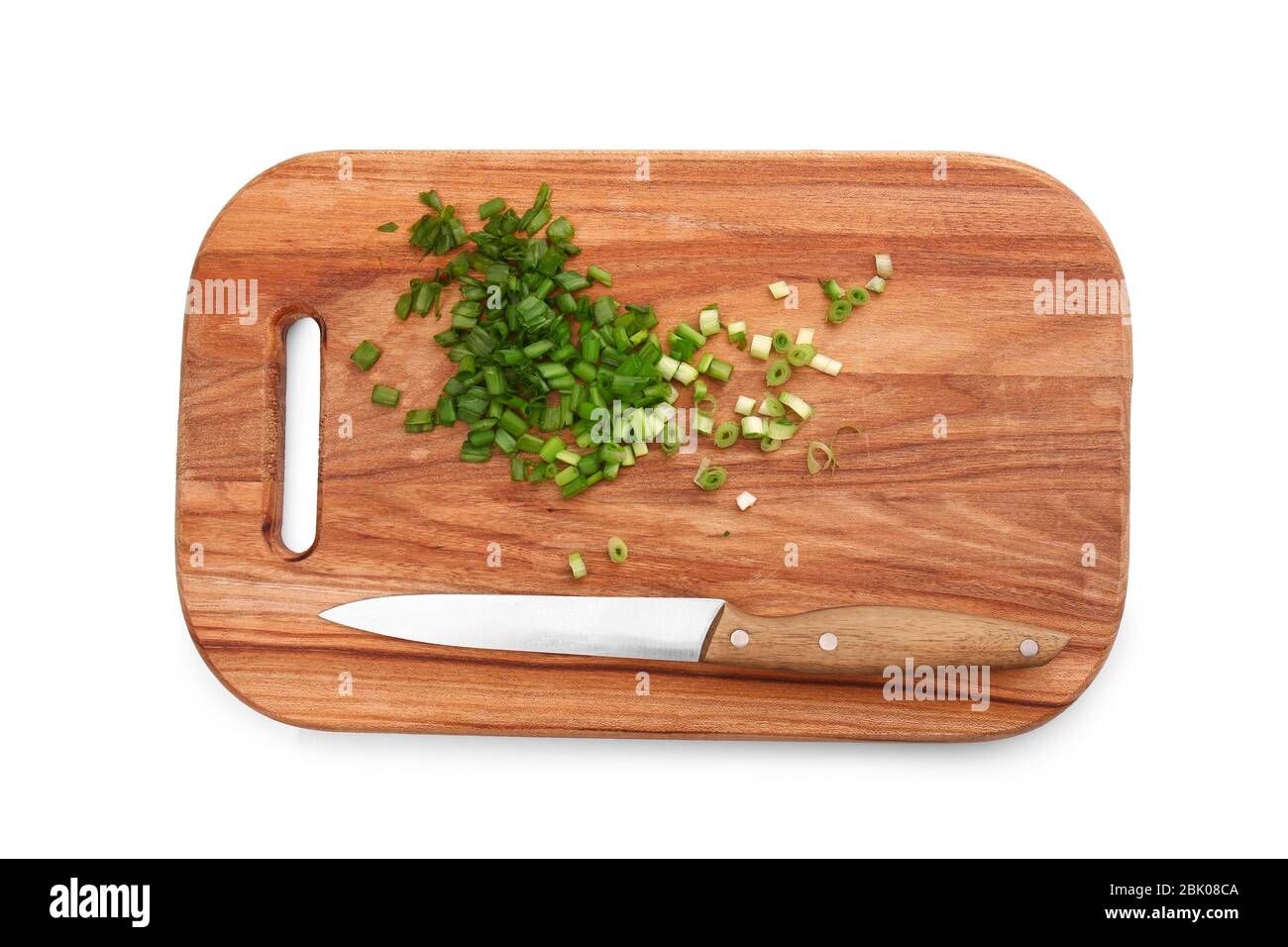 Cutting board with fresh green onion and knife on white background ...
