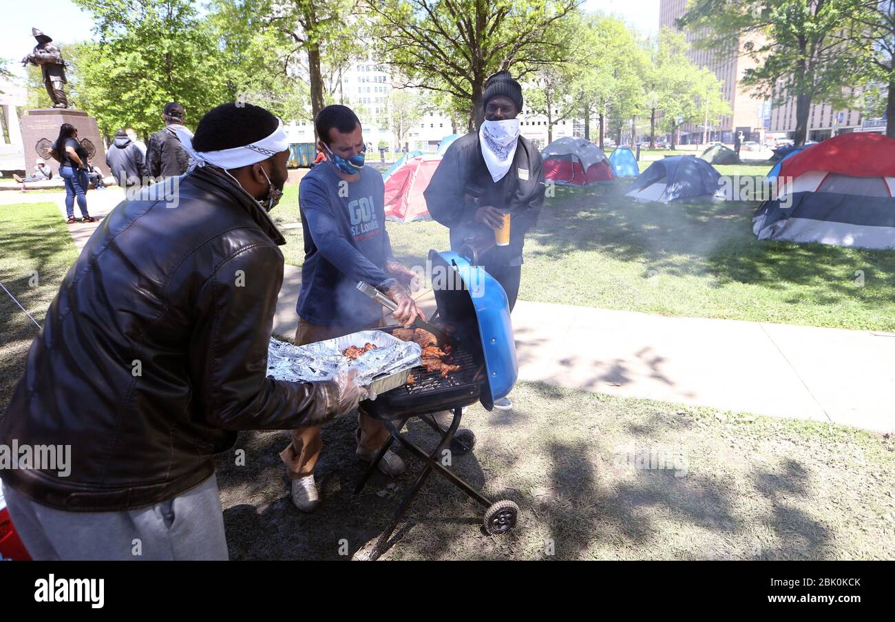 St. Louis, United States. 30th Apr, 2020. Homeless men bar-b-que at their tent camp that has been set up in downtown St. Louis on Thursday, April 30, 2020. The tent city has been in place for several weeks prompting St. Louis Mayor Lyda Krewson to order the homeless be moved on May 1, 2020, due to unhealthy conditions and the danger of coronavirus spreading among the 50 plus tent sites. Photo by Bill Greenblatt/UPI Credit: UPI/Alamy Live News Stock Photo