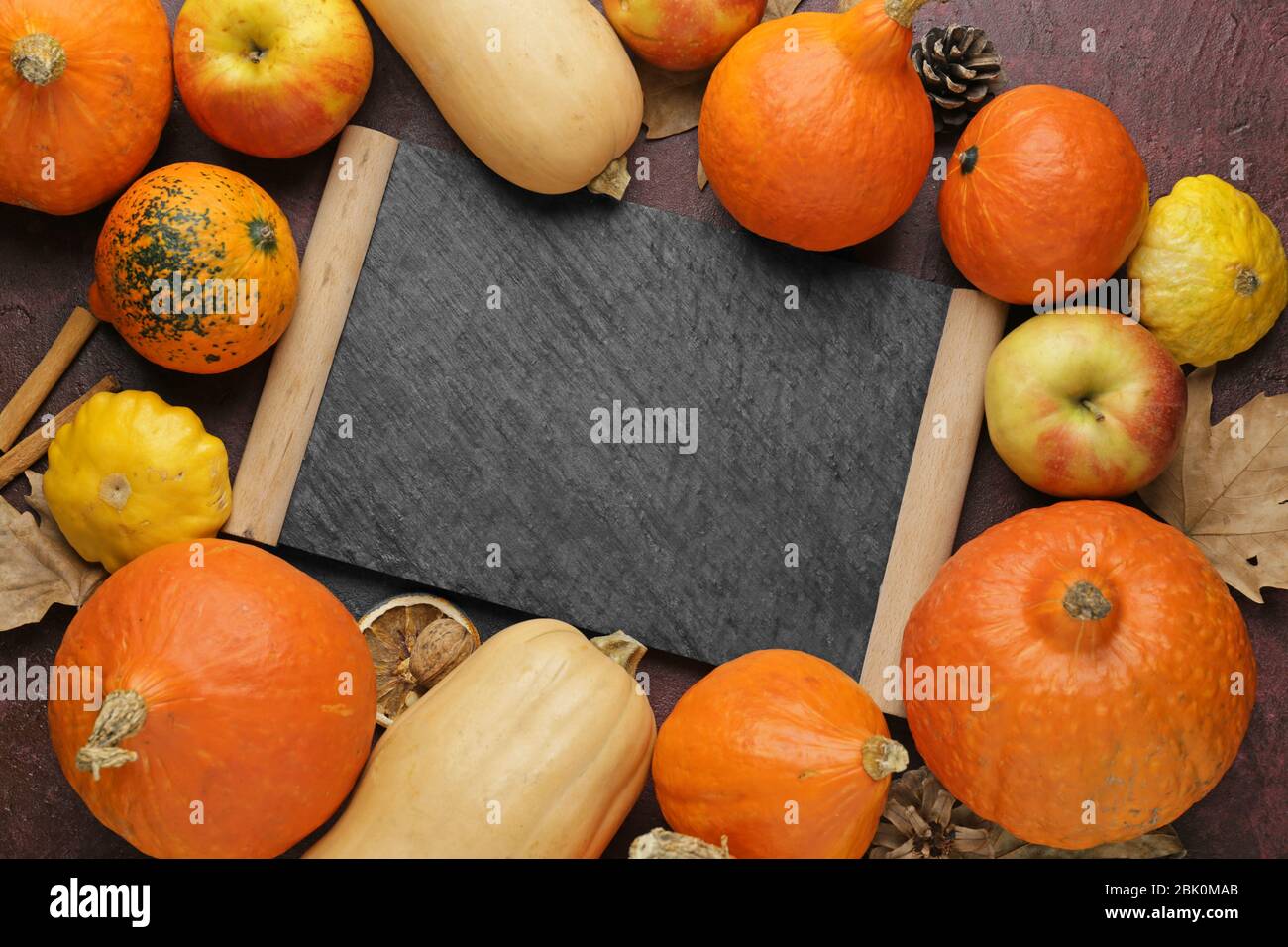 Autumn composition with fresh pumpkins and chalkboard on color background Stock Photo - Alamy