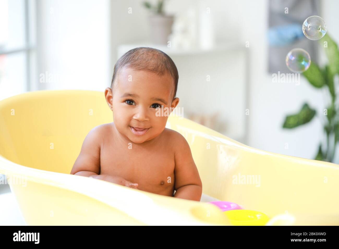 Little AfricanAmerican baby washing in bathtub at home Stock Photo Alamy