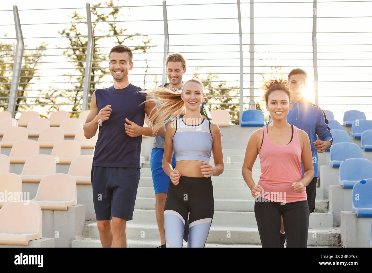 Group of sporty young people training at the stadium Stock Photo - Alamy