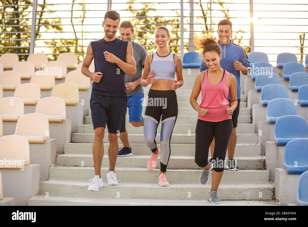 Group of sporty young people training at the stadium Stock Photo - Alamy