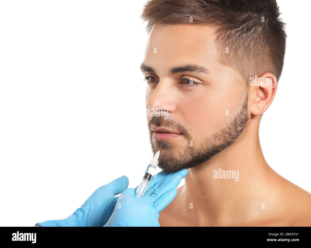 Handsome man receiving filler injection on white background Stock Photo