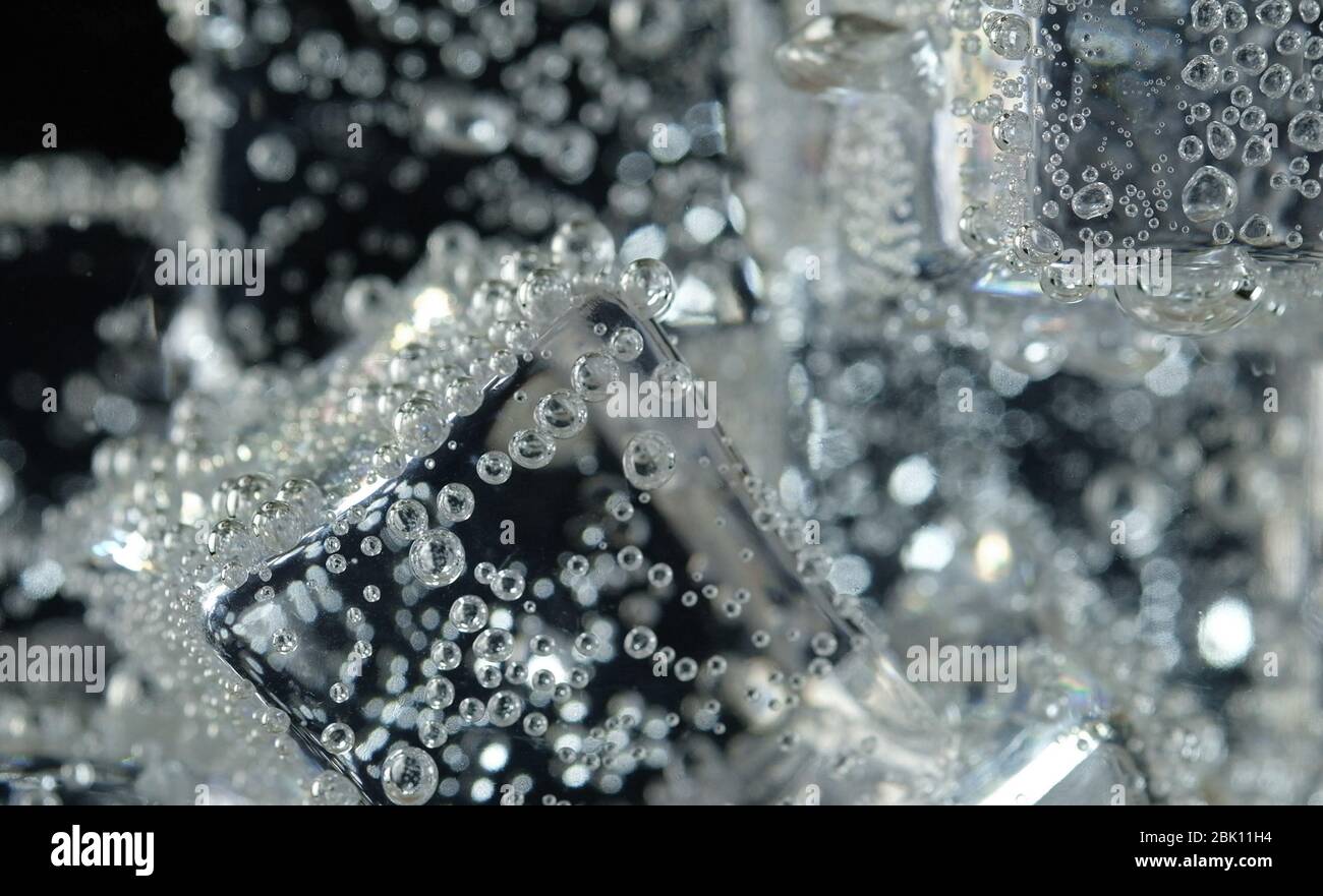 ice cube in fizzy splashing water with soda bubble Stock Photo - Alamy