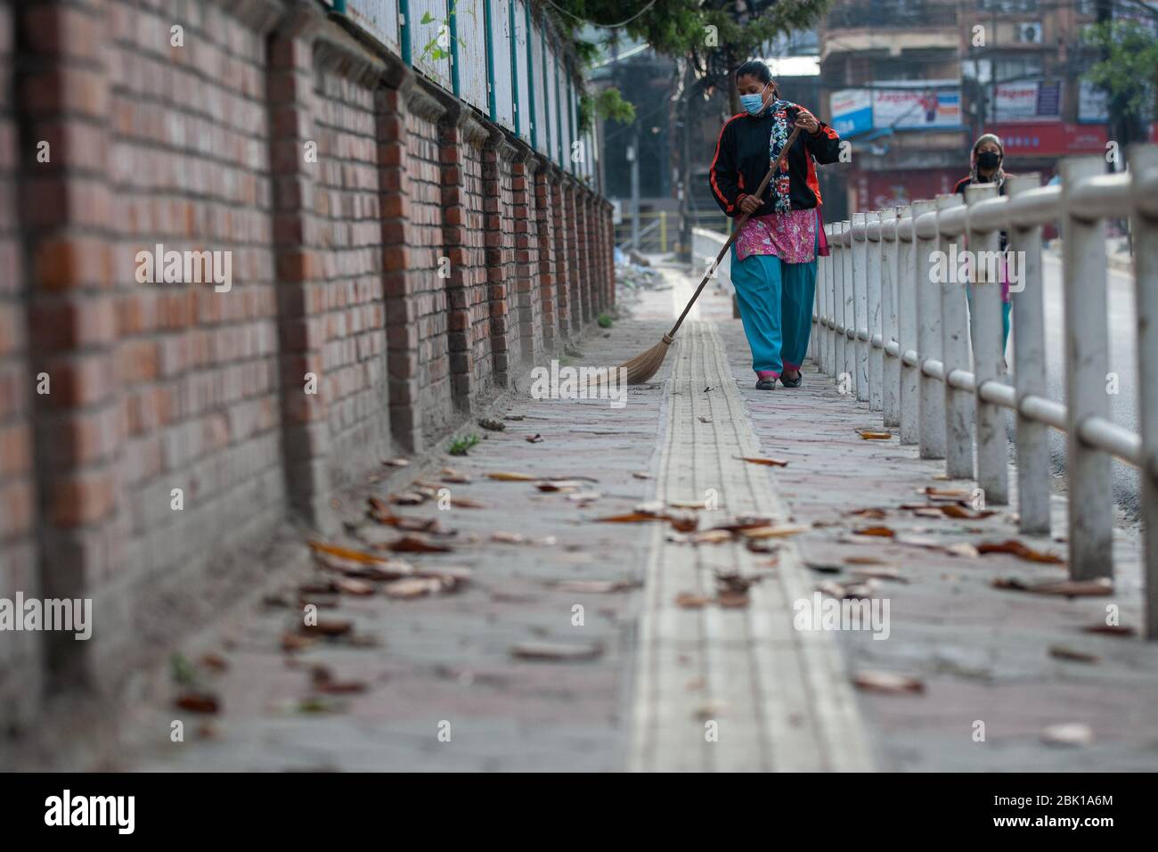 A female worker cleans the street during the International labour day amid the nationwide lockdown imposed by the government amid concerns about the spread of the coronavirus disease (COVID-19).On the occasion of International Workers Day or Labour Day is observed all over the world on the first day of May, the history of this day dates back to the 19th century, when revolutions took place in the United States. It was during the rise of industrialisation that the labour-class was oppressed to the point of having to take a stand. Stock Photo