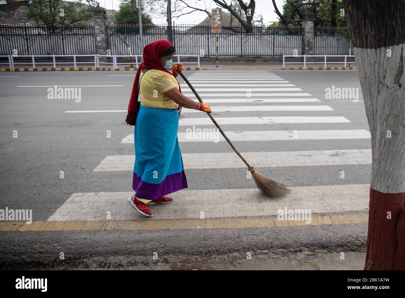 A female worker cleans the street during the International labour day amid the nationwide lockdown imposed by the government amid concerns about the spread of the coronavirus disease (COVID-19).On the occasion of International Workers Day or Labour Day is observed all over the world on the first day of May, the history of this day dates back to the 19th century, when revolutions took place in the United States. It was during the rise of industrialisation that the labour-class was oppressed to the point of having to take a stand. Stock Photo