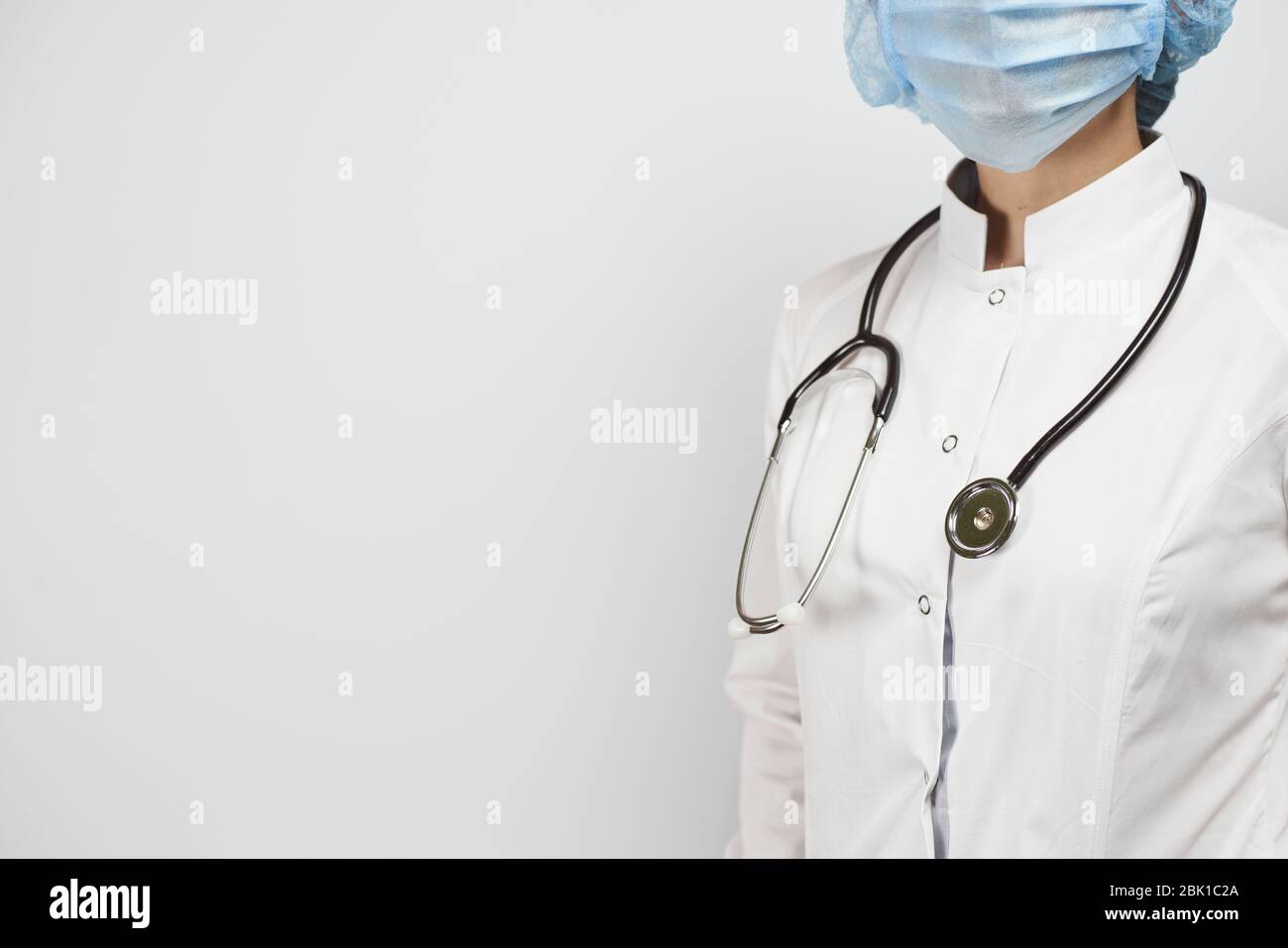 Cropped view of female doctor posing with stethoscope in uniform ...