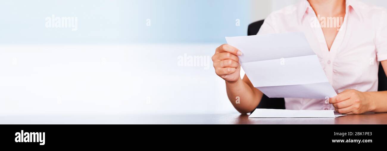Woman Opening Letter Envelop And Reading Bill Stock Photo
