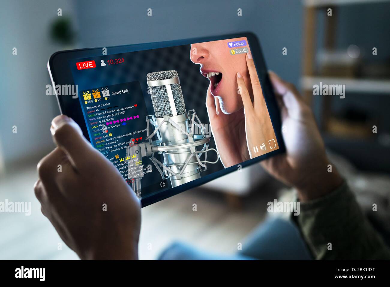 Streaming Live Music Video With Singer On Tablet Computer Stock Photo
