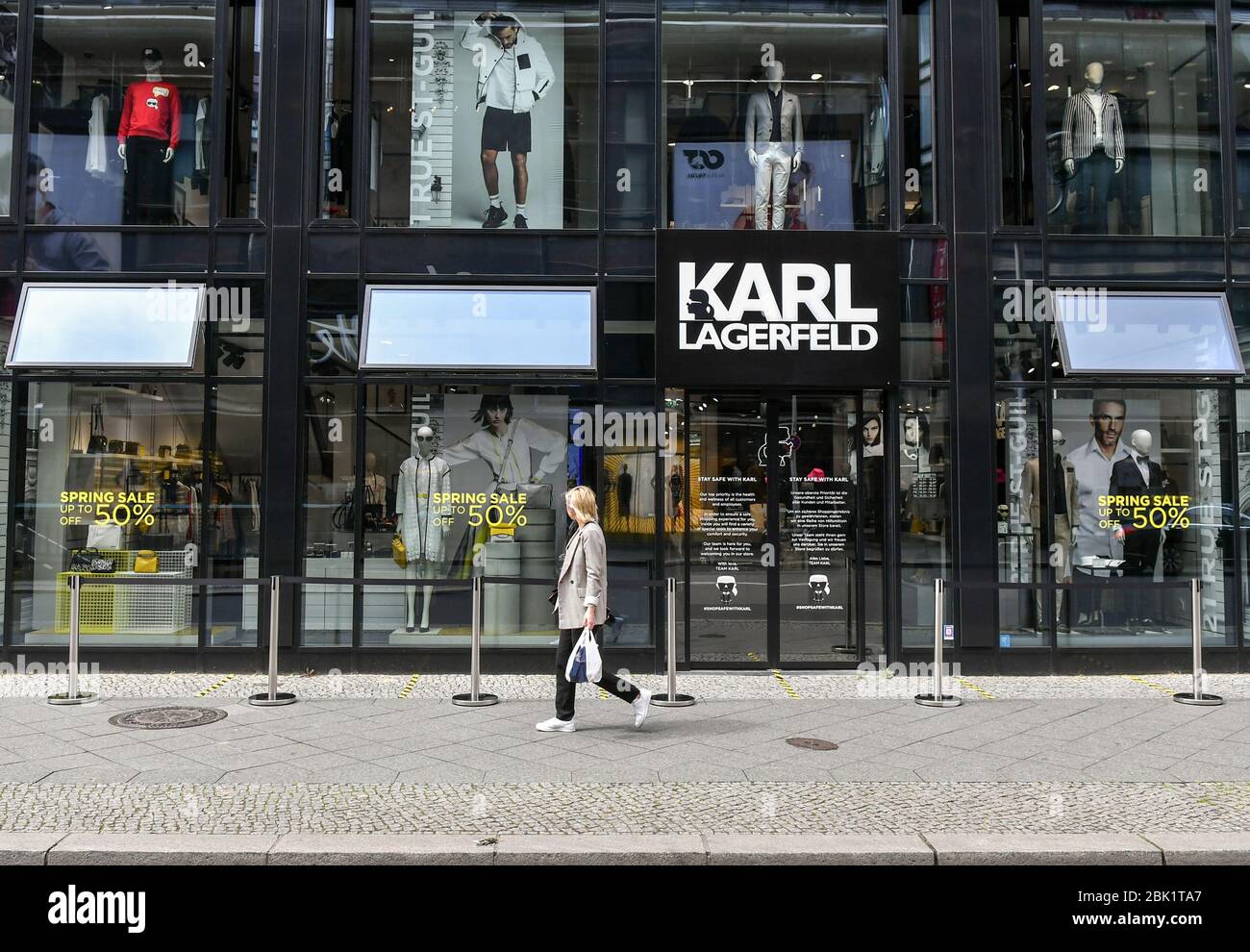 Berlin, Germany. 30th Apr, 2020. The Karl Lagerfeld Boutique in  Friedrichstraße has attached logos of the Karl figure with mouthguards at  the entrance. The brand's shops have now reopened with a hygiene