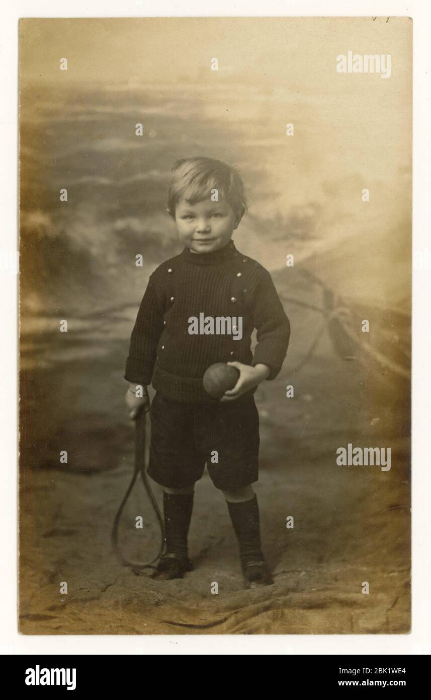 Early 1900's seaside postcard of young boy holding a bat and ball, Eastbourne, Sussex, England, U.K. circa 1908 Stock Photo