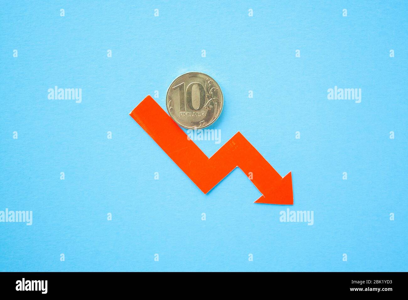 ten rouble coin on blue background with red arrow down. exchange rate ...