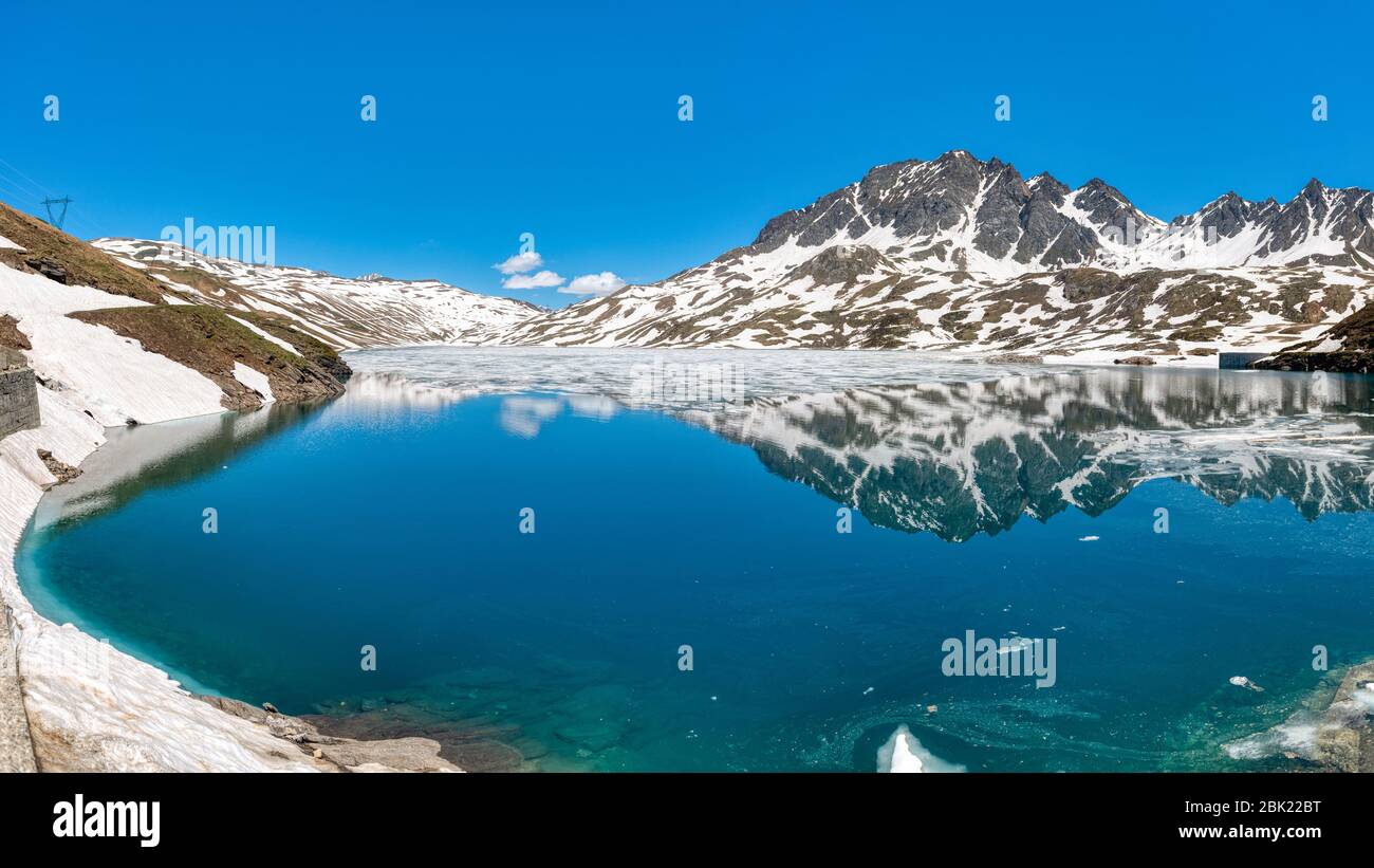 the thaw on the lake of Toggia in the mountains of Formazza valley with clesr sky in background Stock Photo