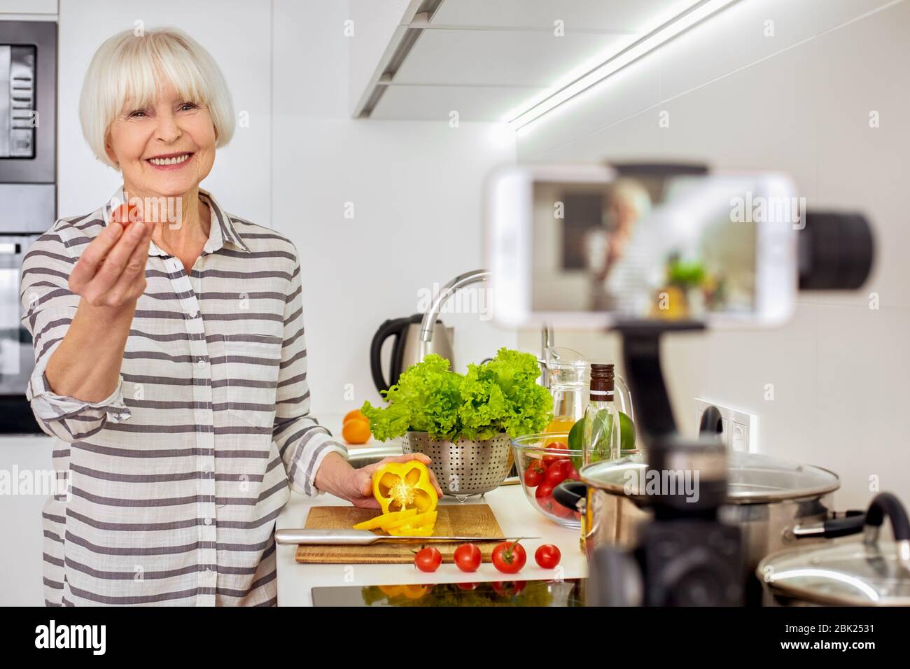 Grey hair woman using modern smartphone, cooking food, recording video Stock Photo - Alamy Grey hair woman using modern smartphone, cooking food, recording video Stock Photo - Alamy