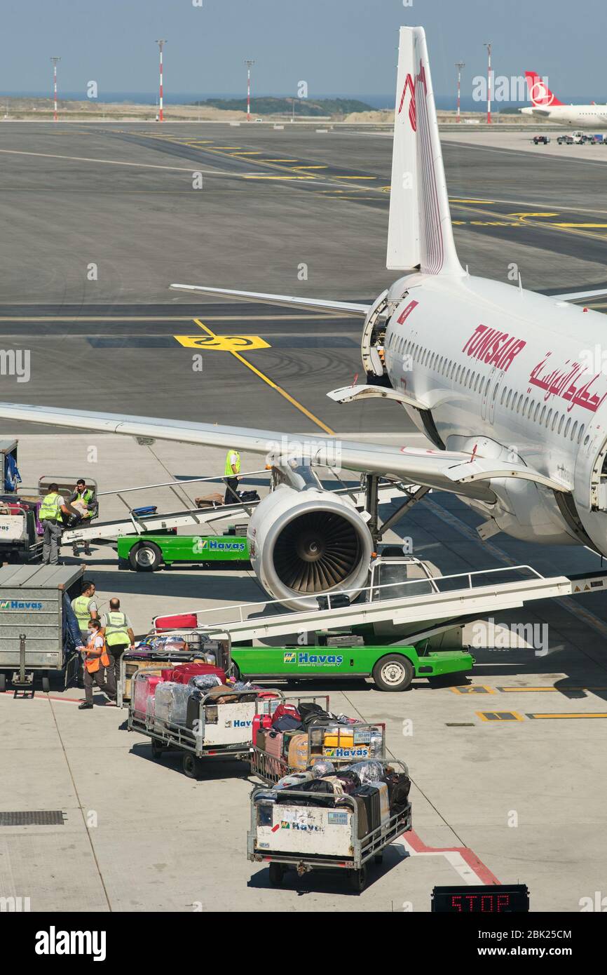 Istanbul / Turkey - September 14, 2019: Airport workers loading the luggage bags into a Tunisair Airbus A320 at the new Istanbul Airport, Istanbul Hav Stock Photo