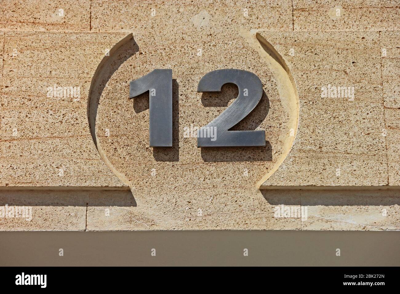 Number 12 engraved into door lintel Stock Photo