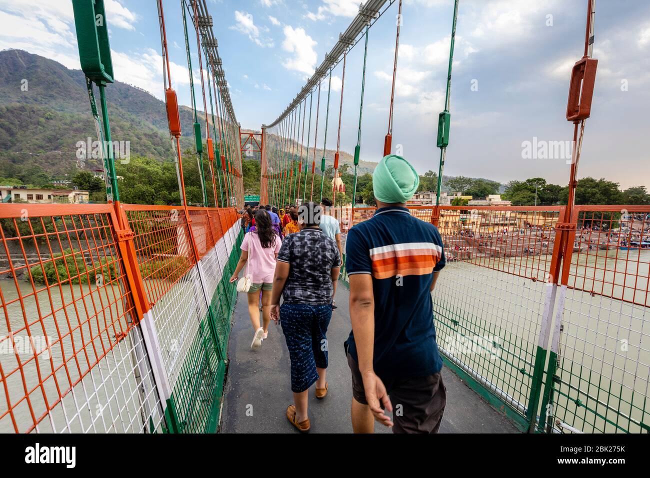 Pilgrims crop the famous Ram Jhula in the spiritual city of Rishikesh in India Stock Photo