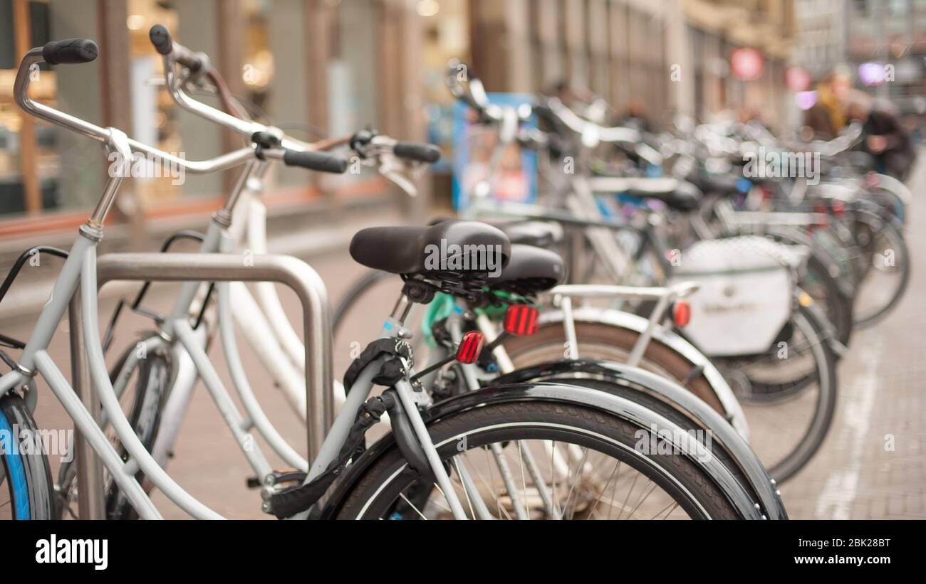 Group of a lot of old holland vintage classic bicycles row parked at  parking station in public. Cityscape view. Dutch lifestyle Stock Photo -  Alamy