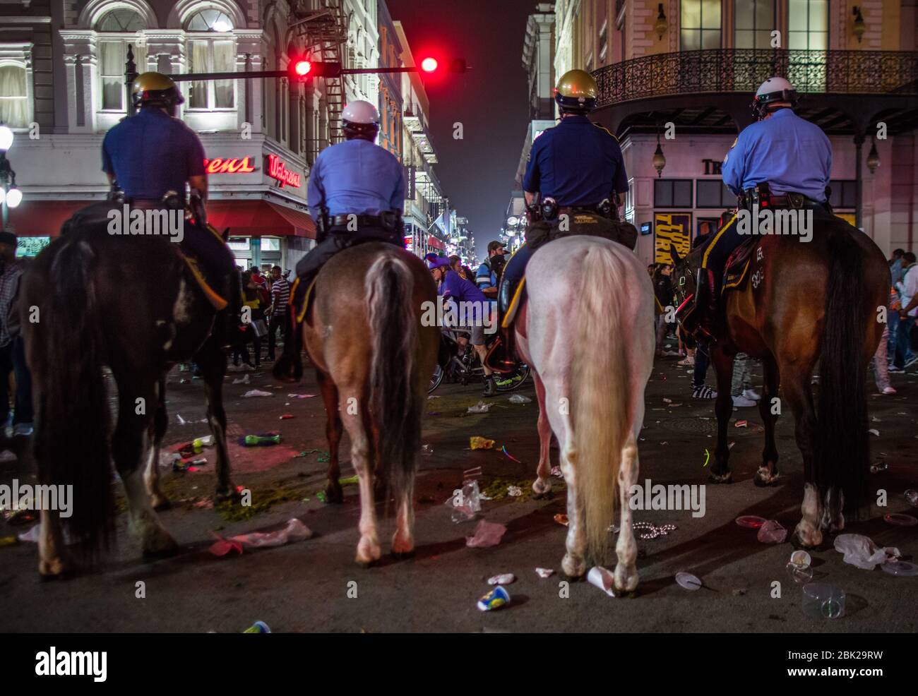 Mounted Policemen monitoring safety of revelers at Canal St at the edge of the French District in New Orleans during Mardis Gras Stock Photo
