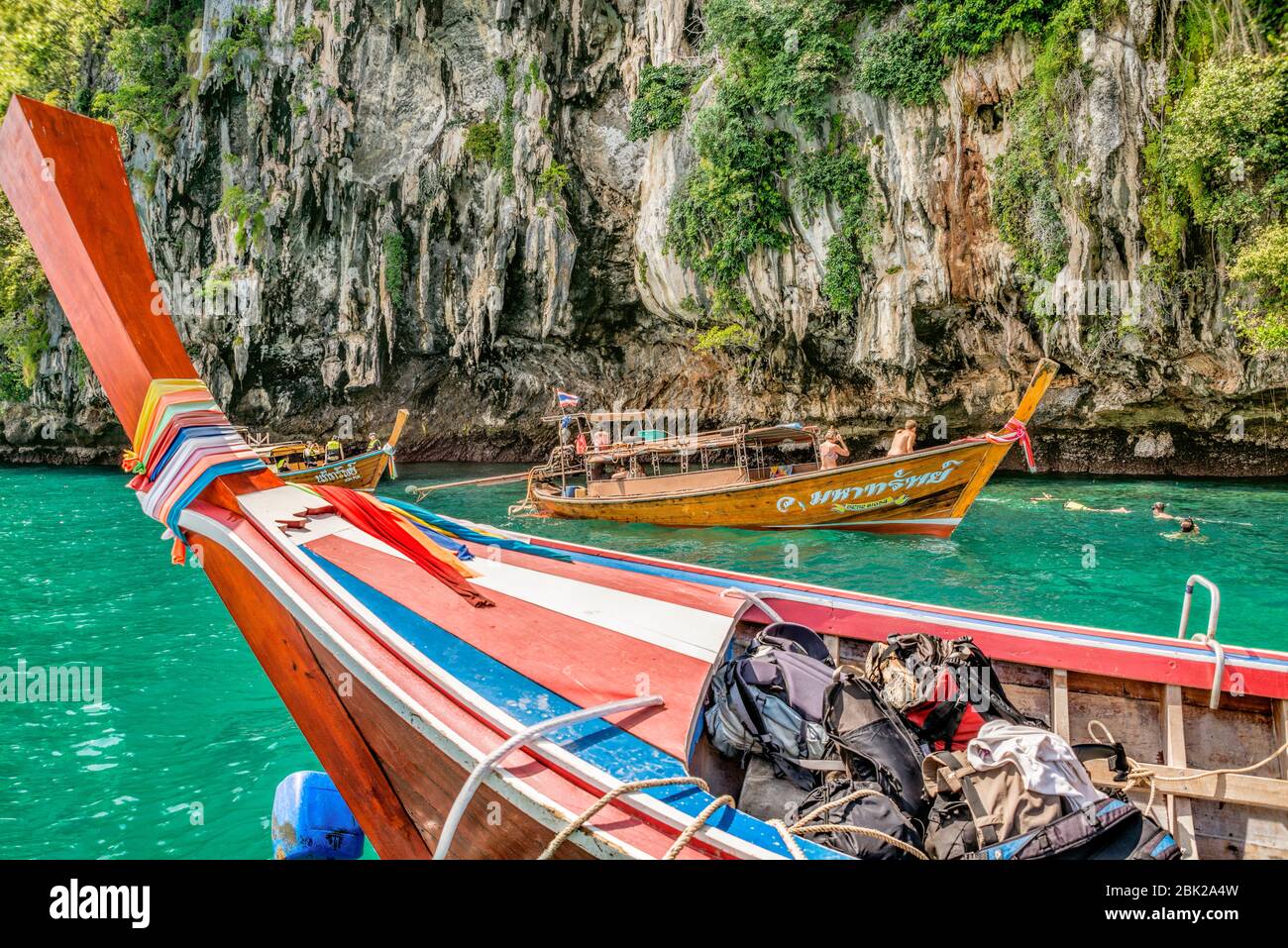 Thai long tail boats with tourists at Koh Chuek near Koh Lanta, Krabi, Thailand Stock Photo