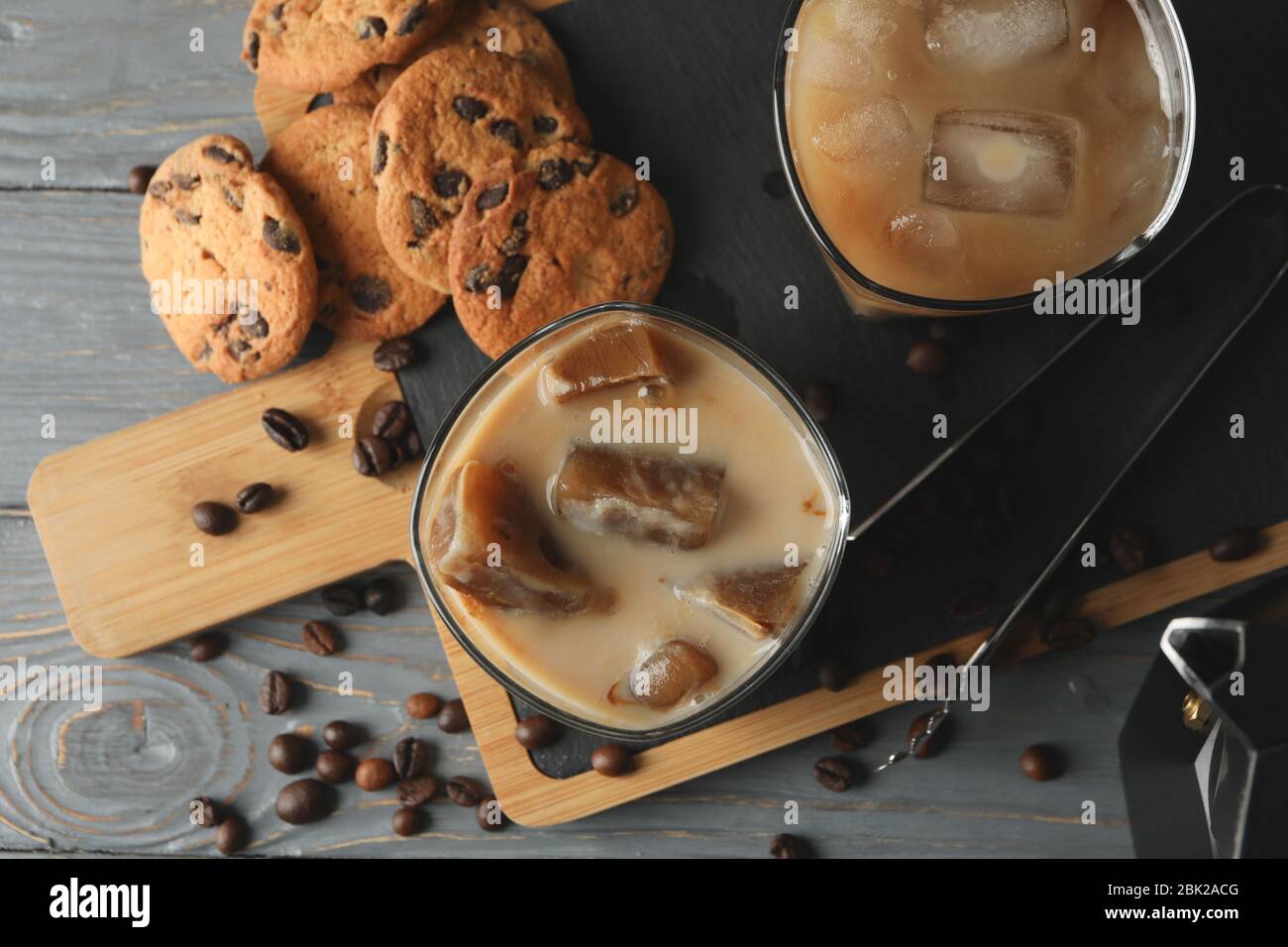 Composition with ice coffee and cookies on wooden background Stock Photo