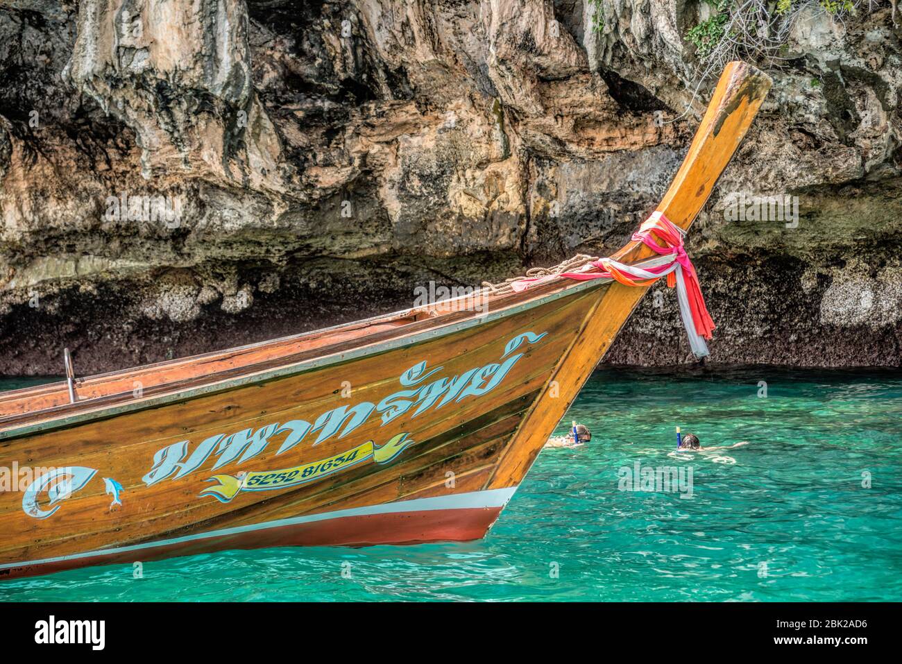 Thai long tail boats with tourists at Koh Chuek near Koh Lanta, Krabi, Thailand Stock Photo