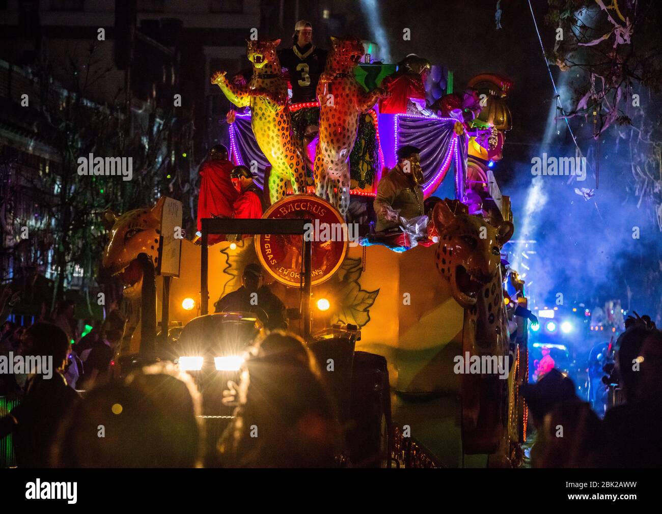 A float from Krewe Bacchus tossing beads to spectators during Mardis Gras in New Orleans, Louisiana Stock Photo