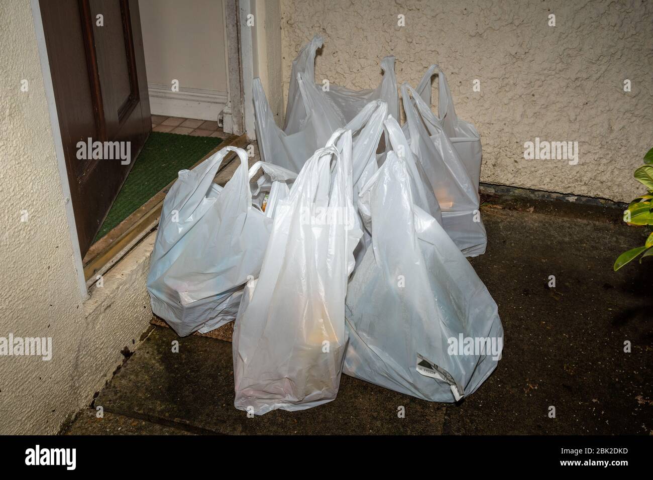 Supermarket food home delivery online Asda order delivered left on the doorstep late evening during the coronavirus covid-19 pandemic, 2020, UK Stock Photo