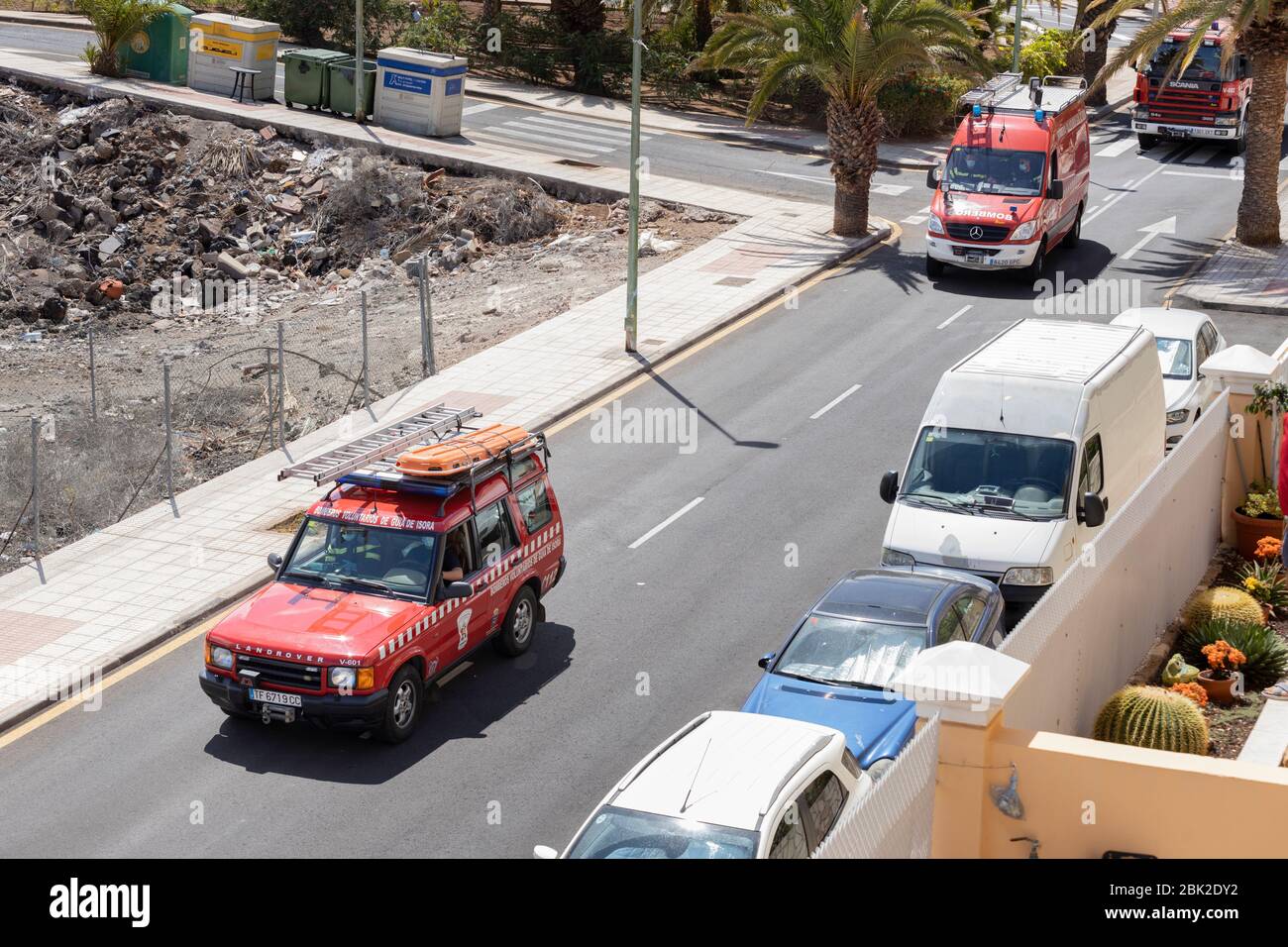 Volunteer firemen drive through the village with sirens and lights flashing, covid 19 state of emergency, Playa San Juan, Tenerife, Canary Islands, Stock Photo