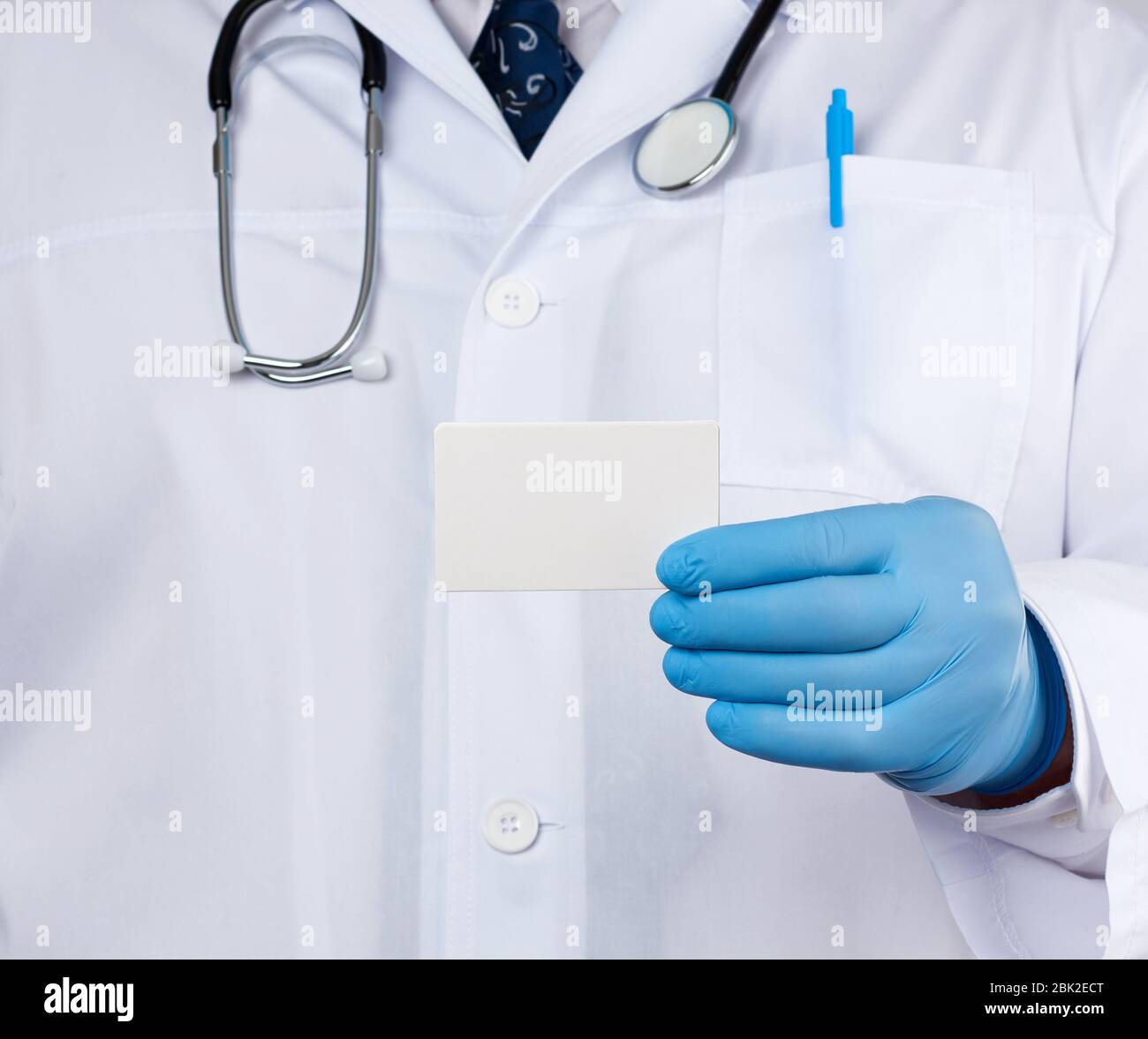 doctor therapist is dressed in a white robe uniform and blue sterile ...