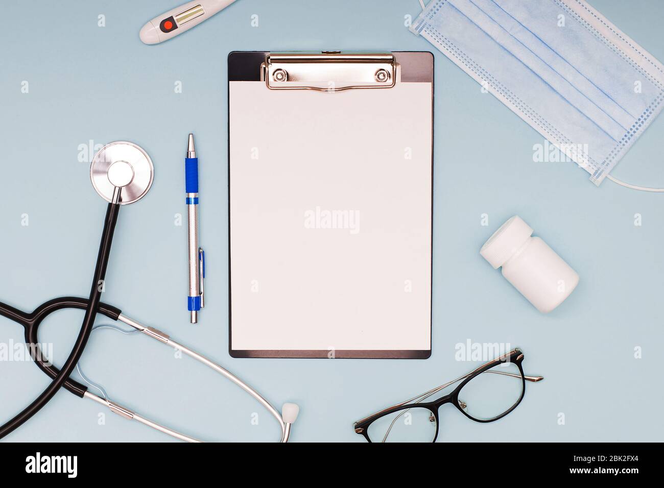 Flat lay with stethoscope, medical mask, glasses and other objects Stock Photo