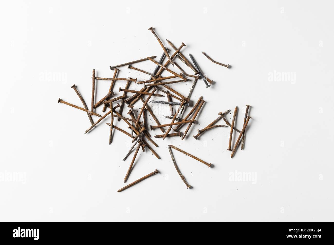 Rusty nails piling isolated on white background. Stock Photo