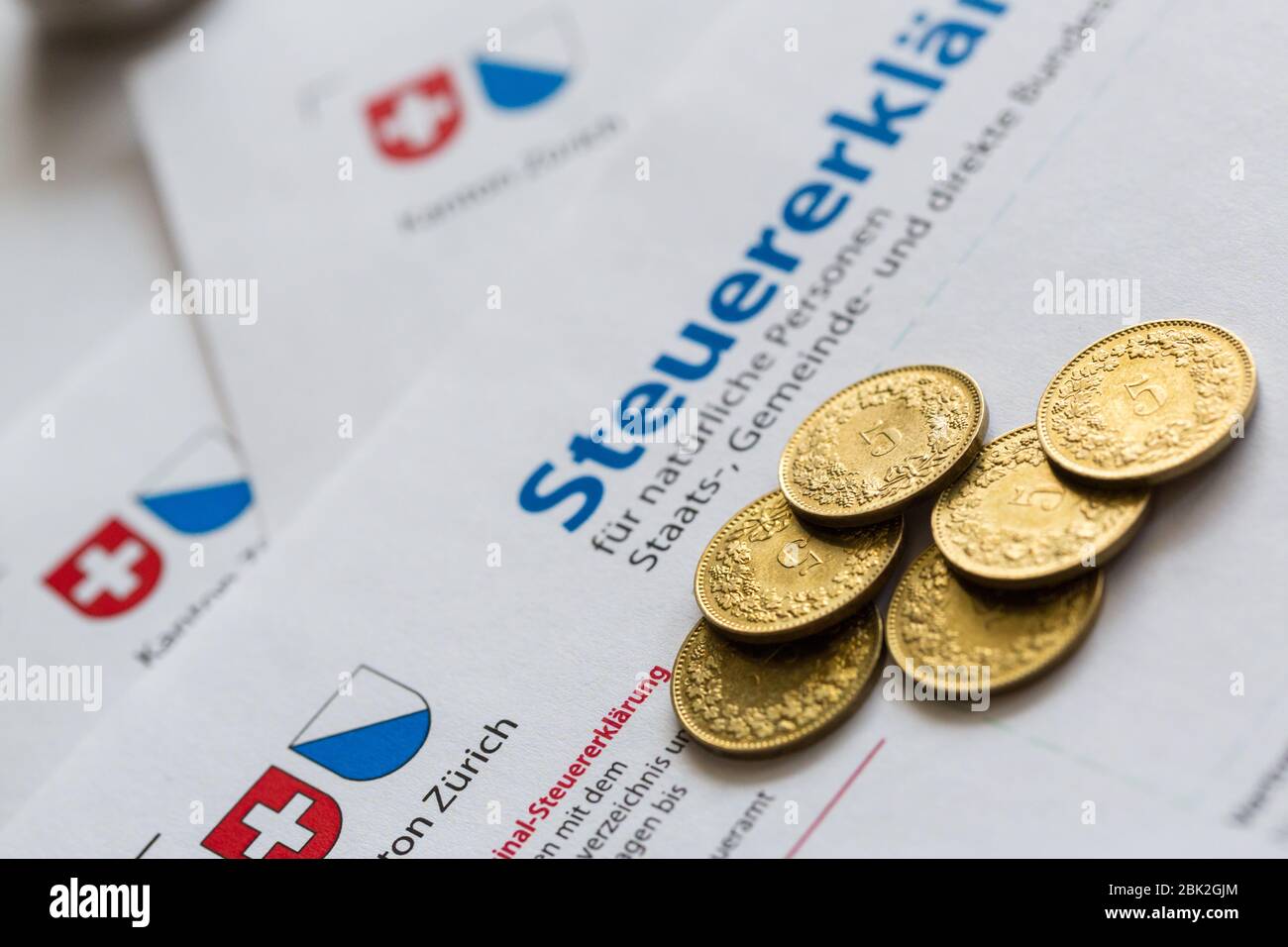 six golden coins on paper of Swiss tax declaration form, Canton of