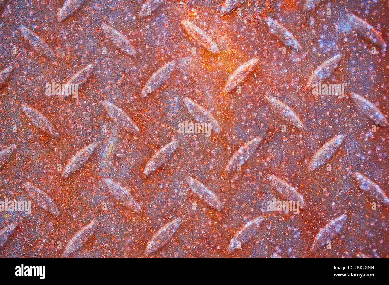 An old, rusty, colored plate with traces of background painting Stock Photo