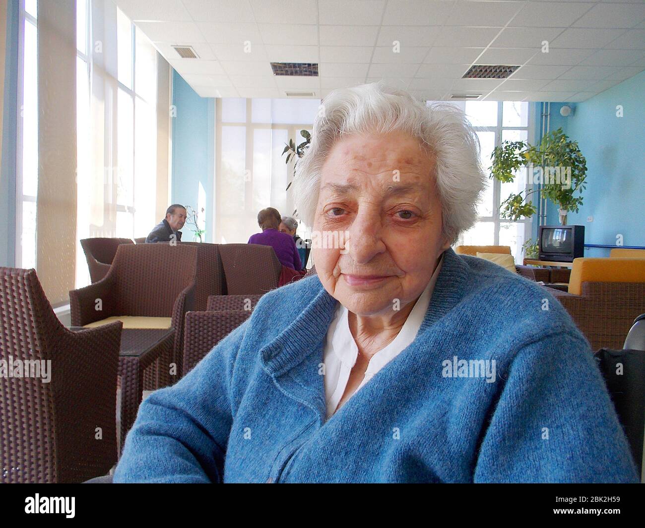 Old lady in a nursing home, smiling and looking at the camera. Stock Photo