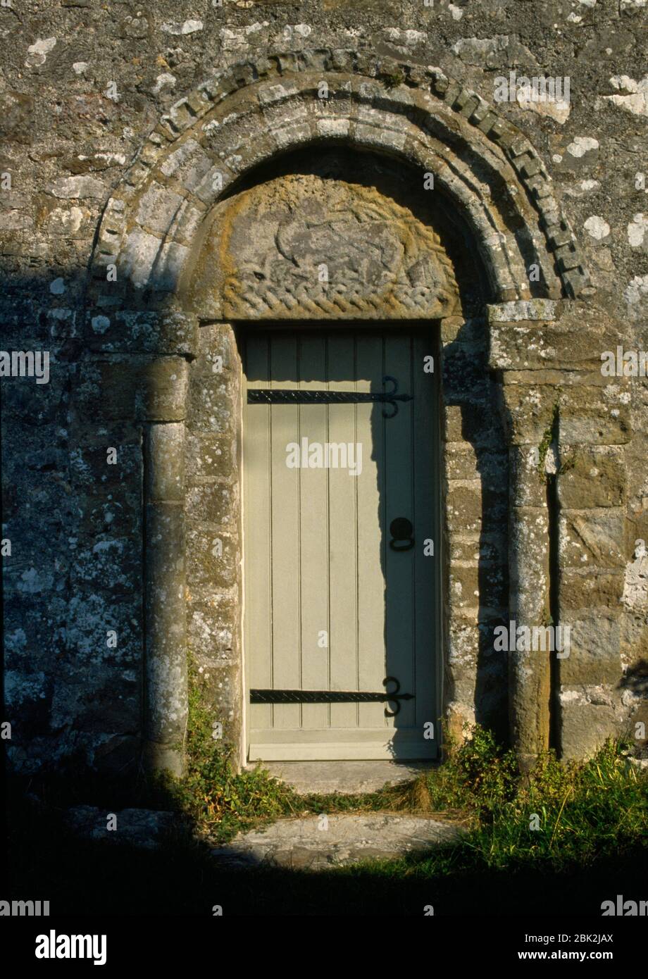 The C12th S doorway to the nave of St Seiriol's Church, Penmon Priory, Anglesey, Wales, UK