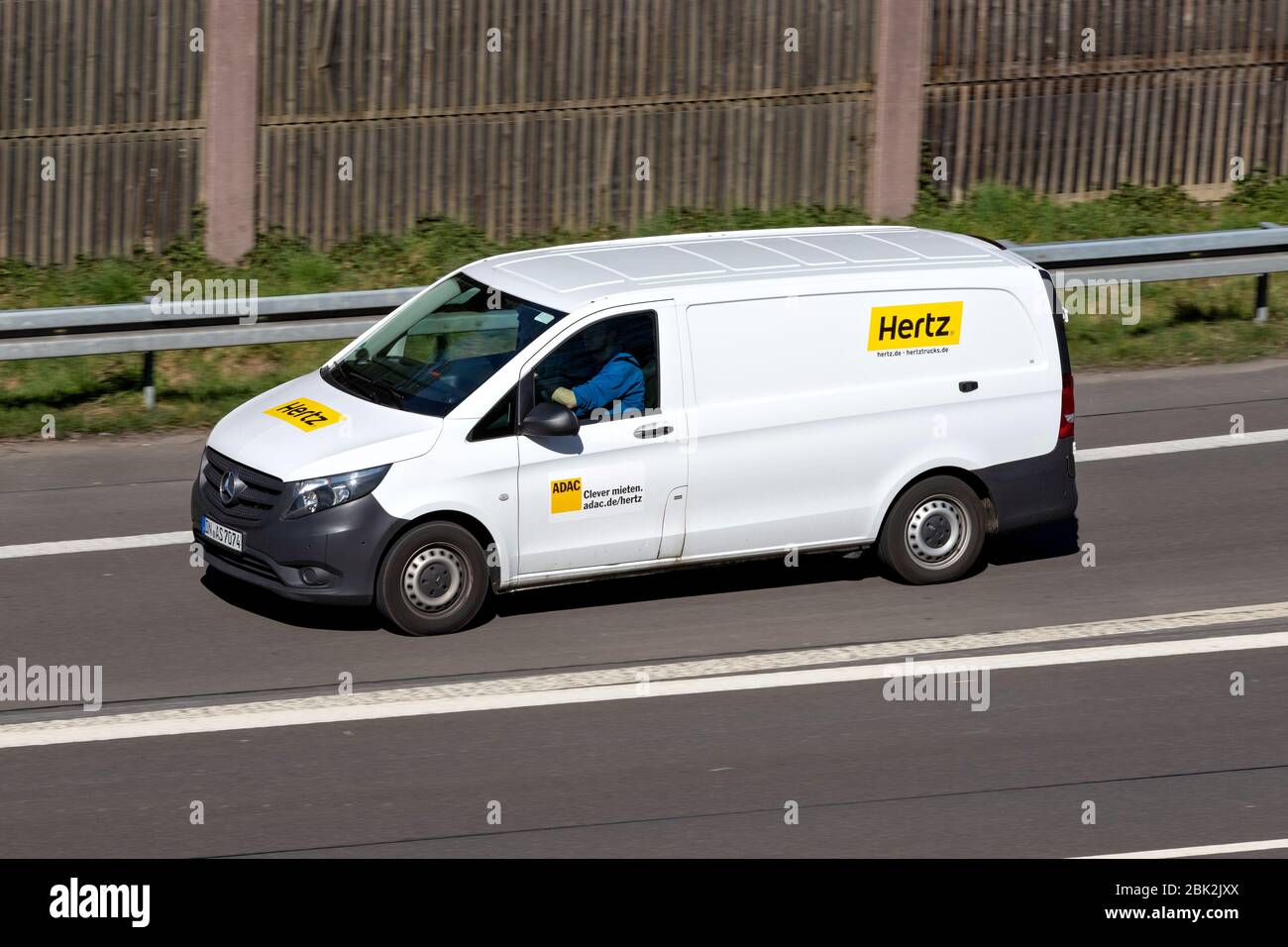 Mercedes-Benz Vito of Hertz on motorway. The Hertz Corporation is an American car rental company based in Estero, Florida. Stock Photo