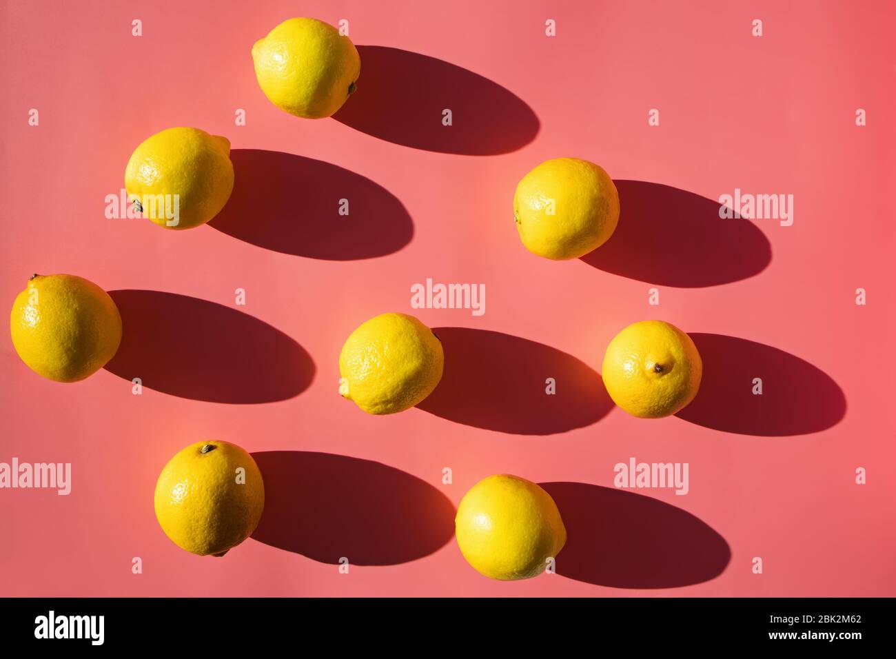Flat lay composition with lemons on pink background, Stock Photo