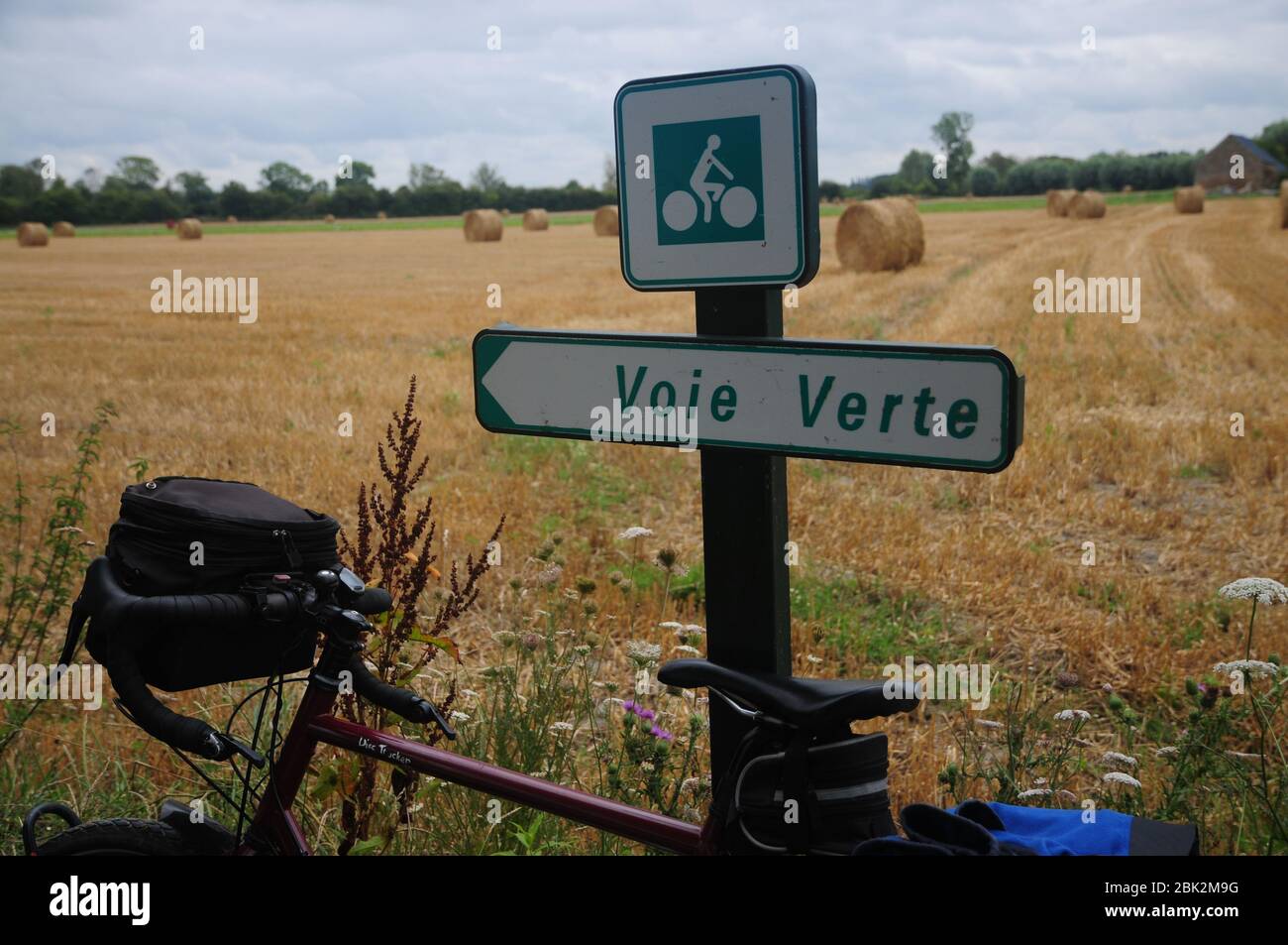 Cycle leaning against a sign for the 'Voie Verte' or 'Green Way' a network of waymarked quiet cycle routes in France Stock Photo