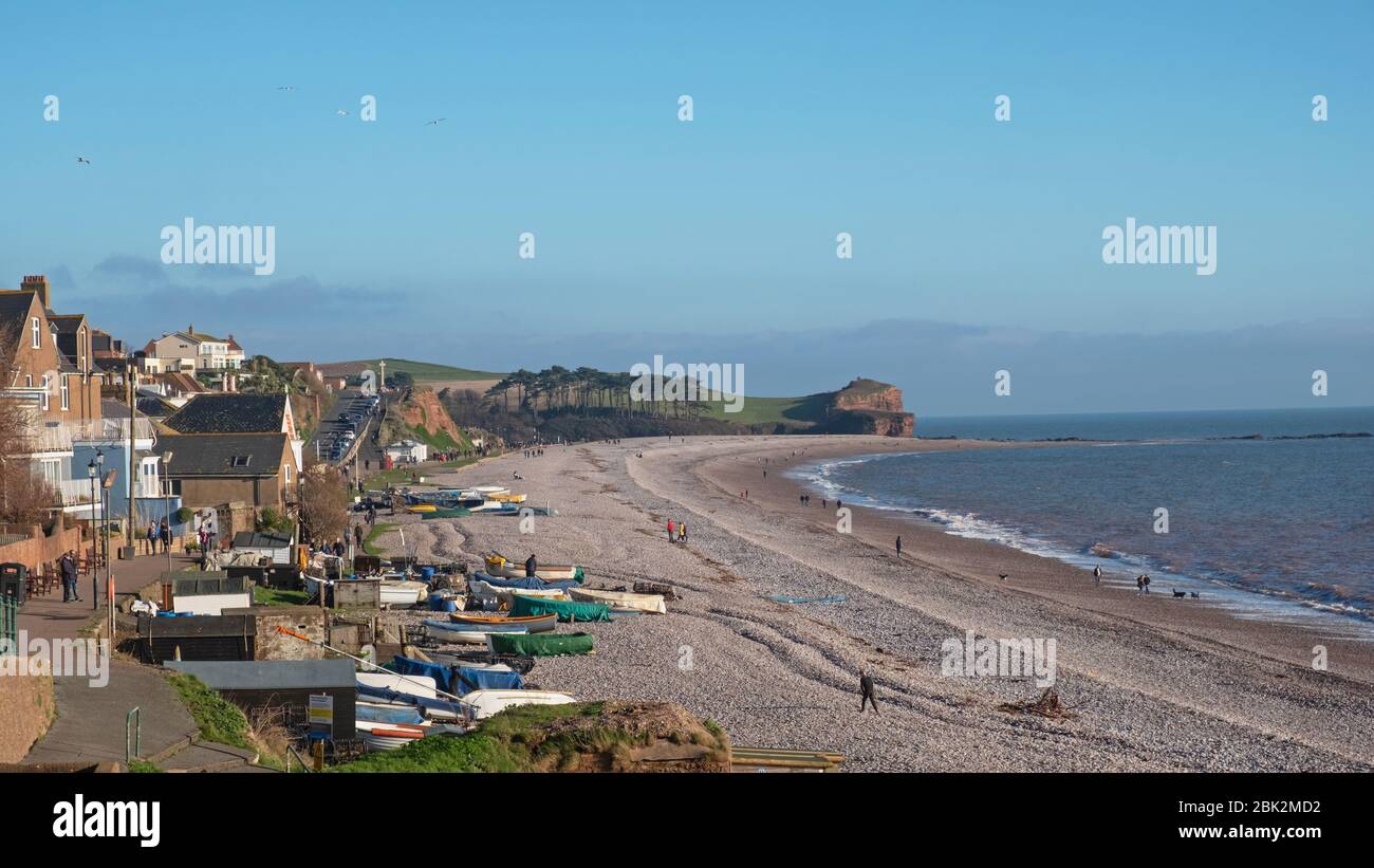 Budleigh Salterton, England – December 30, 2019: People taking advantage of winter sunshine in the bay of this small coastal town in south east Devon Stock Photo