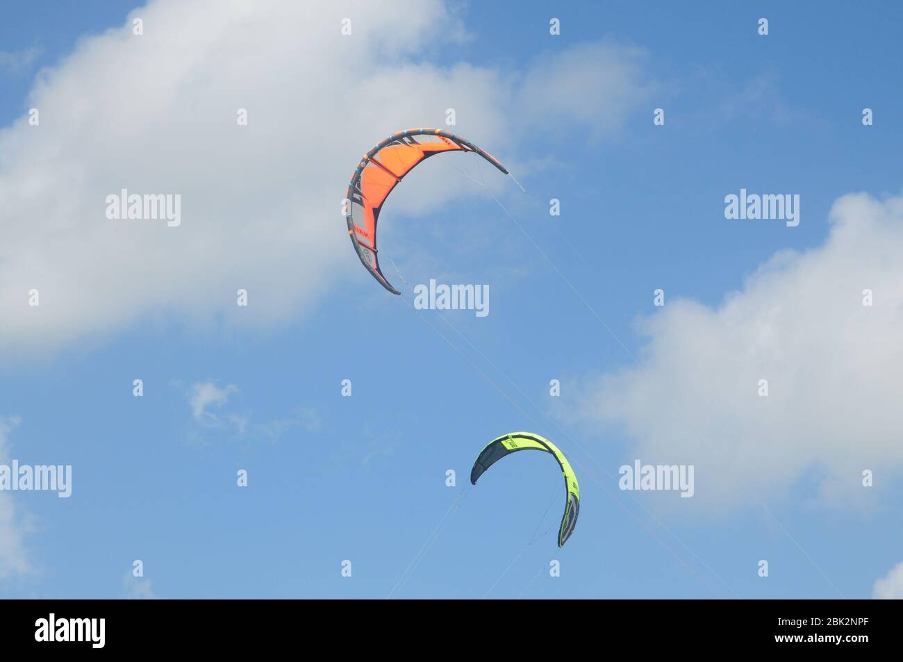 Kite surfing aerofoils or wings flying against a sunny blue sky Stock Photo