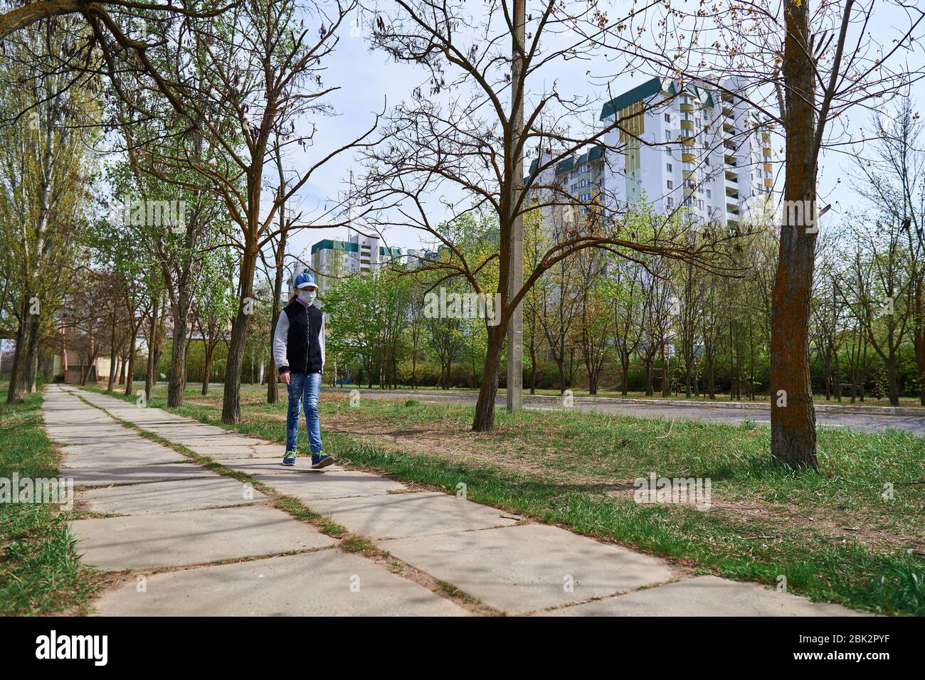 Picture of child girl walks down the street during the day, a pedestrian walkway ...