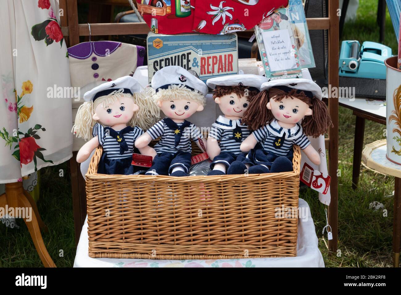A willow basket hamper containing 4 mop head dolls dressed as sailors.  Displayed for sale at a vintage nostalgia festival. England UK Stock Photo  - Alamy