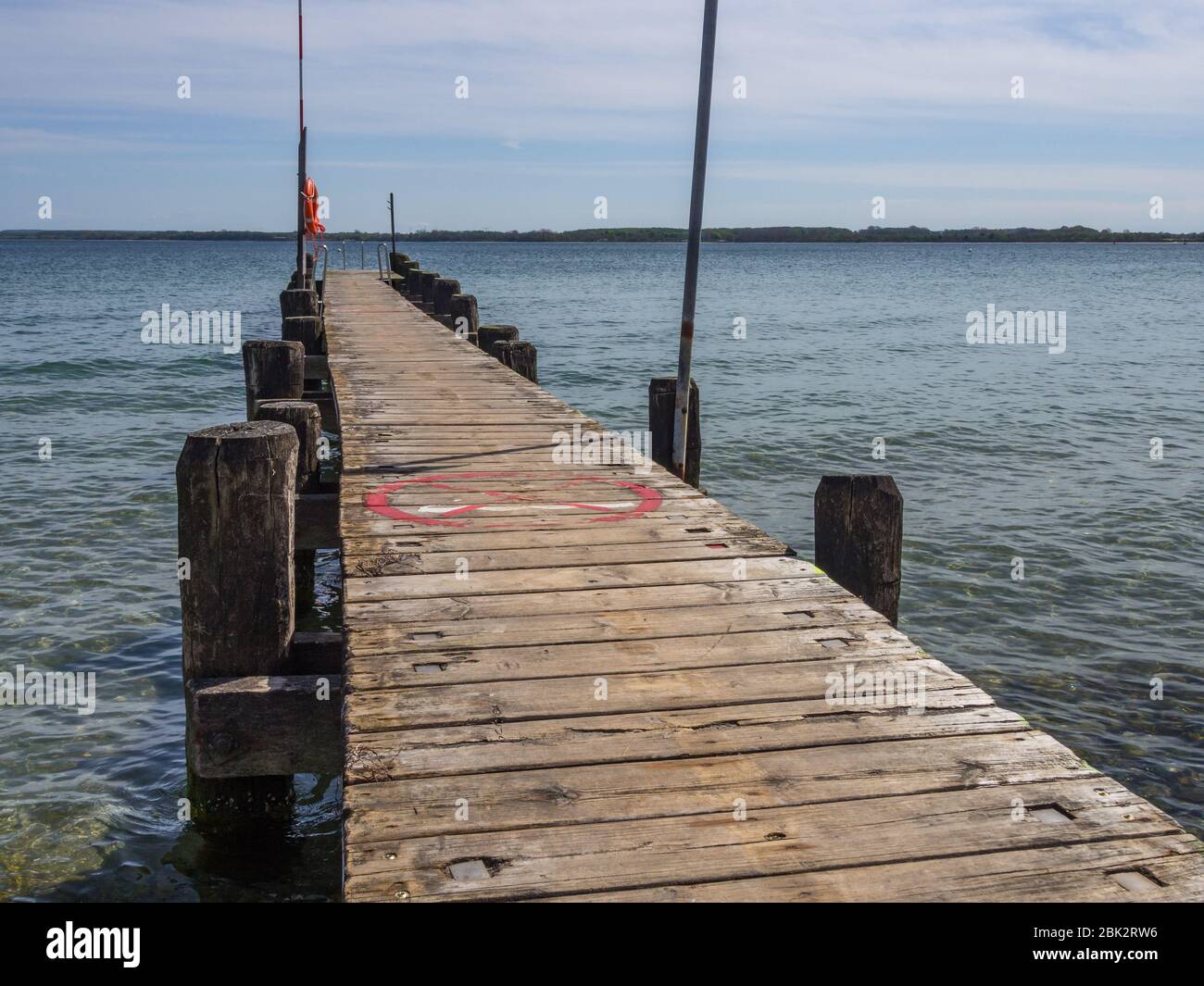 wooden boat landing stage with rescue ring and rescue pole Stock Photo
