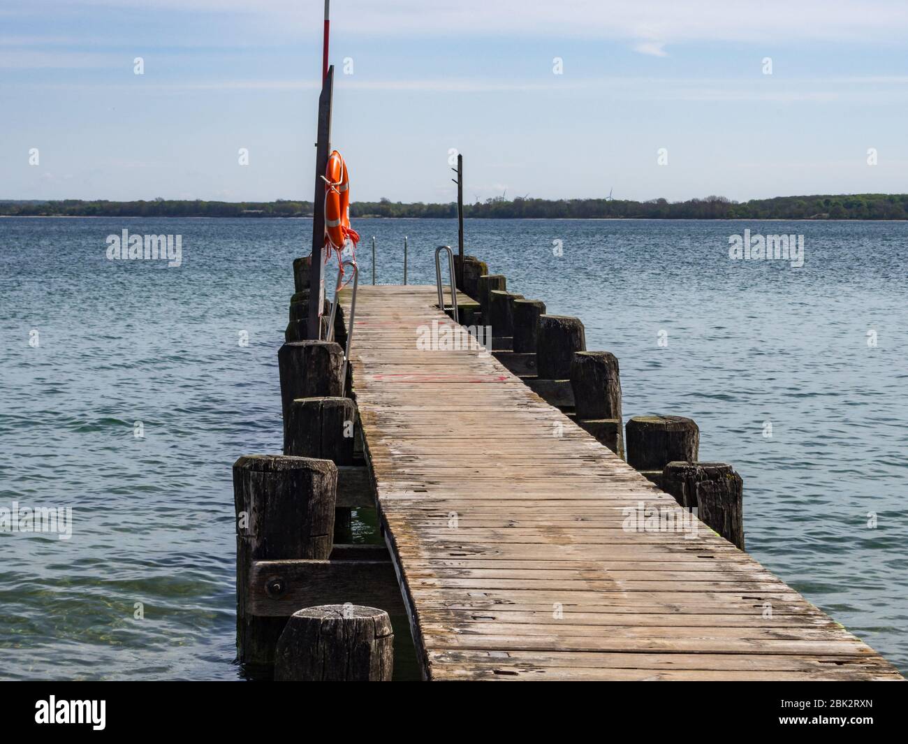 wooden boat landing stage with rescue ring and rescue pole Stock Photo