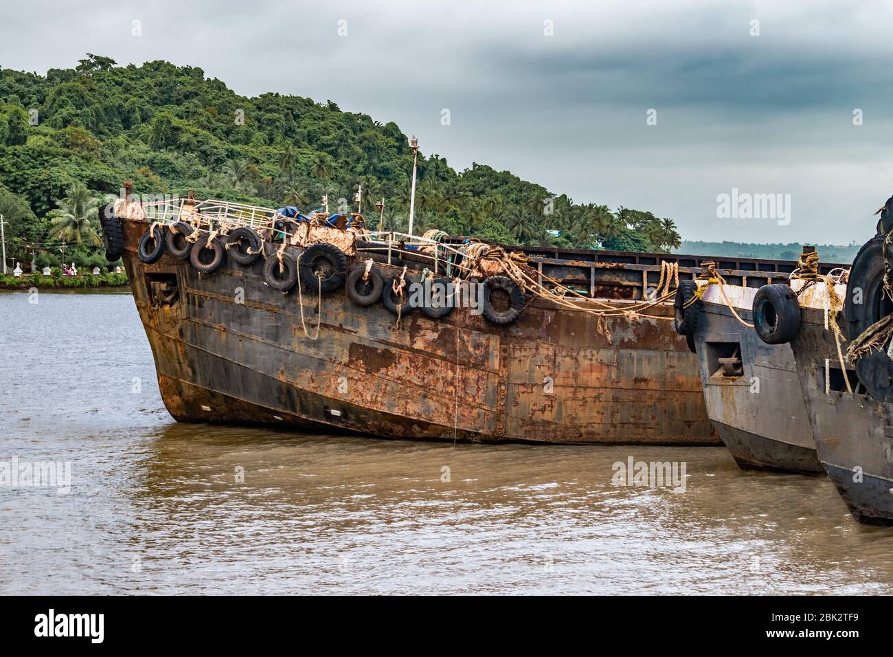 Decommissioned Feeder Vessels aka Barges beached up at Ship Breaking Yard. Used for bulks transportation, now obsolete due to recession and mining ban Stock Photo