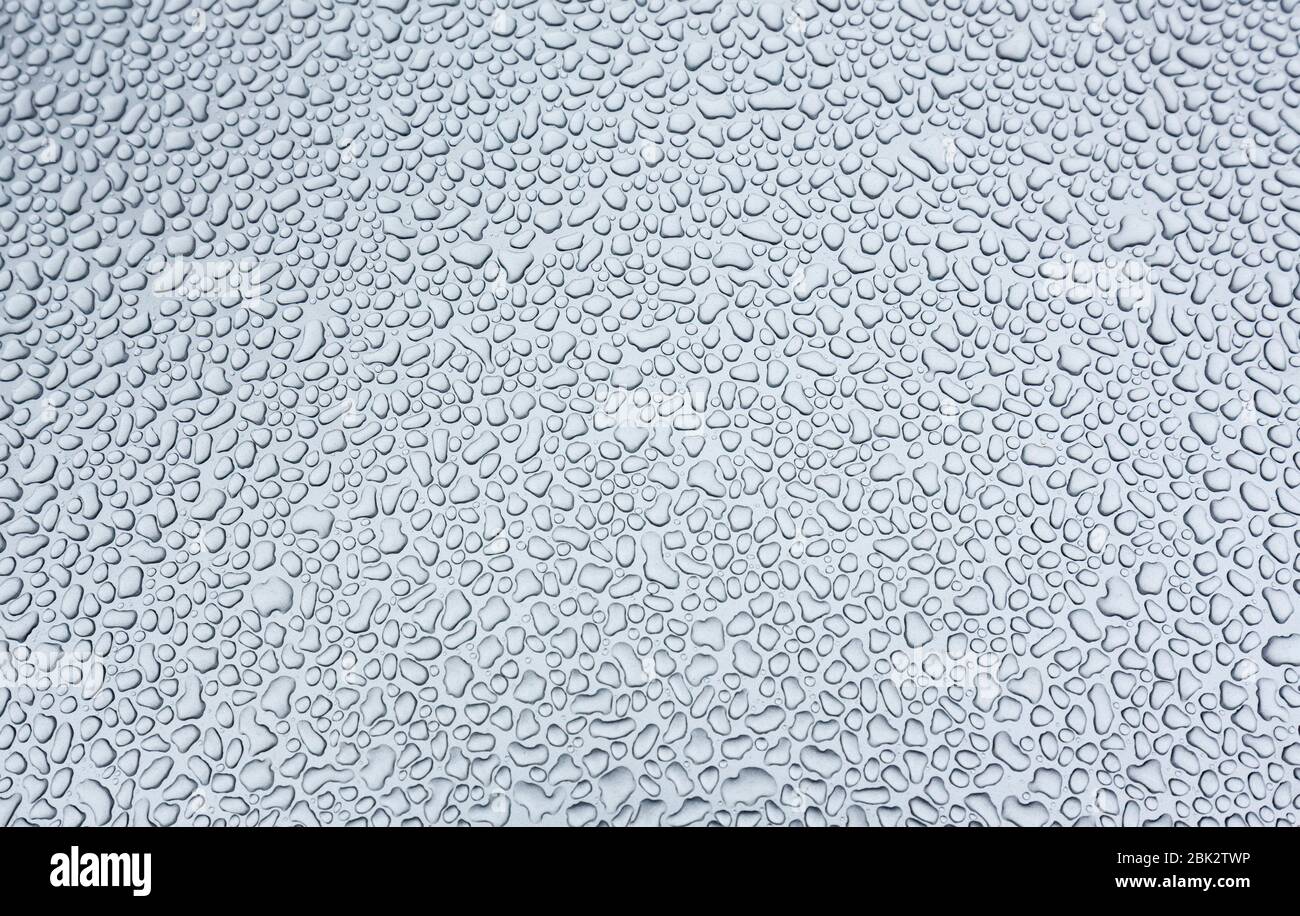 Water drops on silvery metal surface Stock Photo